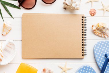 Arka planda plaj aksesuarları olan boş bir kitap, kopyalama alanı. Kopyalama alanı olan düz.