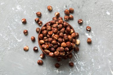 Wooden bowl full of hazelnuts on table background. Healthy eating concept. Super foods.