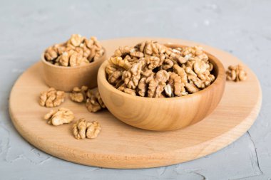 Fresh healthy walnuts in bowl on colored table background. Top view Healthy eating bertholletia concept. Super foods.