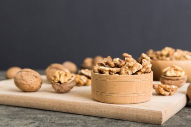 Fresh healthy walnuts in bowl on colored table background. Top view Healthy eating bertholletia concept. Super foods.