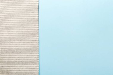 top view with gray kitchen napkin isolated on table background. Folded cloth for mockup with copy space, Flat lay. Minimal style.