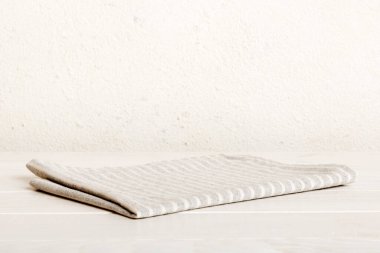 top view with gray kitchen napkin isolated on table background. Folded cloth for mockup with copy space, Flat lay. Minimal style.