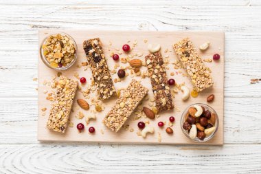 Arka planda çeşitli granola barlar var. Mısır gevreği gofretleri. Yulaf, fındık ve böğürtlenli kahvaltı barları, yakın çekim. Süper yiyecek konsepti.