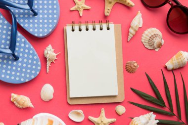 Blank writing book with summer beach accessories on background, copy space. Flat lay with copy space.