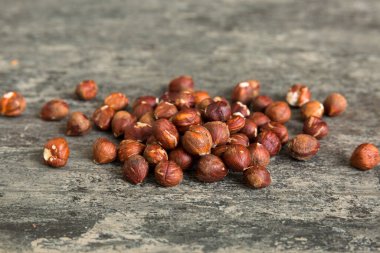 Wooden bowl full of hazelnuts on table background. Healthy eating concept. Super foods.