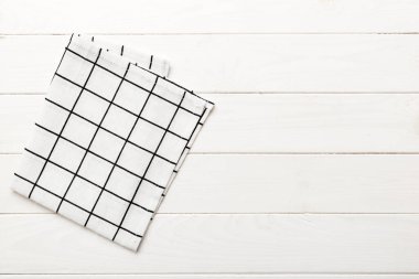 top view with white empty kitchen napkin isolated on table background. Folded cloth for mockup with copy space, Flat lay. Minimal style.