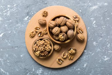 Fresh healthy walnuts in bowl on colored table background. Top view Healthy eating bertholletia concept. Super foods.