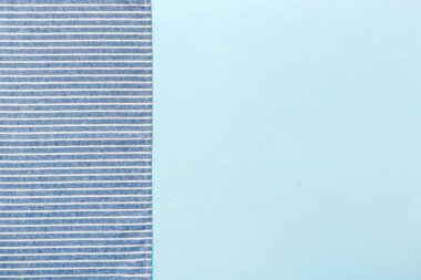 top view with blue kitchen napkin isolated on table background. Folded cloth for mockup with copy space, Flat lay. Minimal style.