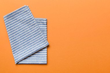 top view with blue kitchen napkin isolated on table background. Folded cloth for mockup with copy space, Flat lay. Minimal style.