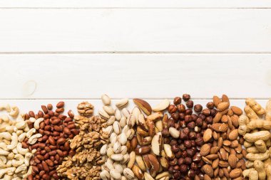 different nuts frame background. Close up, top view, flat lay with vopy space. Walnut, pistachios, almonds, hazelnuts and cashews.