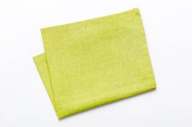 top view with green kitchen napkin isolated on table background. Folded cloth for mockup with copy space, Flat lay. Minimal style.