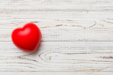 red heart shape on colored background. minimal concept top view with copy space.