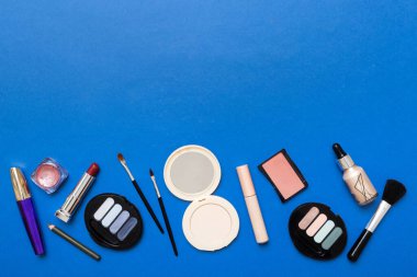 Professional makeup tools. Top view. Flat lay. Beauty, decorative cosmetics. Makeup brushes set and color eyeshadow palette on table background. Minimalistic style.