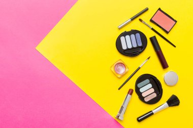Professional makeup tools. Top view. Flat lay. Beauty, decorative cosmetics. Makeup brushes set and color eyeshadow palette on table background. Minimalistic style.