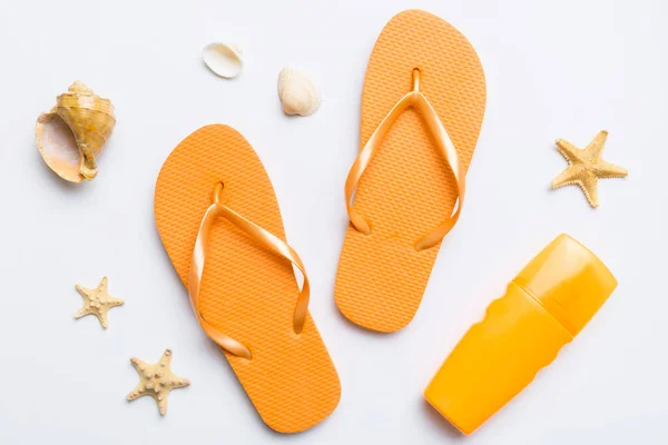 stock image Flat lay composition with flip flops and seashell on colored background. Space for text top view.