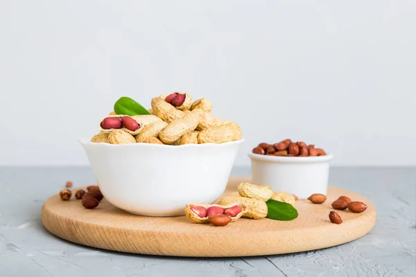 stock image Fresh healthy peanuts in bowl on colored table background. Top view Healthy eating bertholletia concept. Super foods.