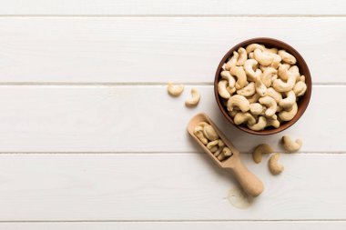 cashew nuts in wooden bowl on table background. top view. Space for text. Healthy food