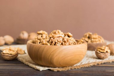 Fresh healthy walnuts in bowl on colored table background. Top view Healthy eating bertholletia concept. Super foods.