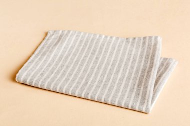 top view with gray kitchen napkin isolated on table background. Folded cloth for mockup with copy space, Flat lay. Minimal style.