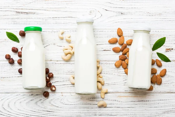 stock image Set or collection of various vegan milk almond, cashew, on table background. Vegan plant based milk and ingredients, top view.