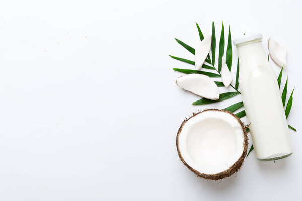 coconut products on white wooden table background. Dairy free milk substitute drink, Flat lay healthy eating.