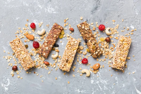 stock image Various granola bars on table background. Cereal granola bars. Superfood breakfast bars with oats, nuts and berries, close up. Superfood concept.