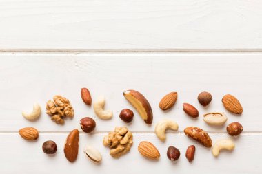 Composition of nuts , flat lay - mix hazelnuts, cashews, almonds on table background. healthy eating concepts and food background.