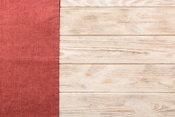 stock image top view with red empty kitchen napkin isolated on table background. Folded cloth for mockup with copy space, Flat lay. Minimal style.