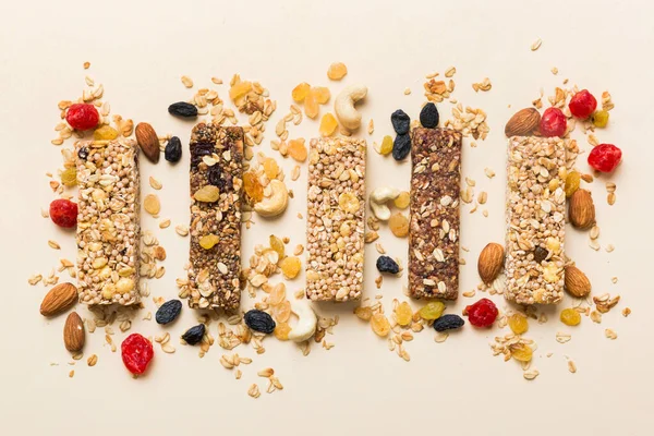 Stock image Various granola bars on table background. Cereal granola bars. Superfood breakfast bars with oats, nuts and berries, close up. Superfood concept.