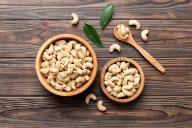 cashew nuts in wooden bowl on table background. top view. Space for text. Healthy food