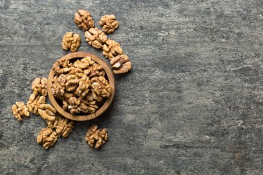 Fresh healthy walnuts in bowl on colored table background. Top view Healthy eating bertholletia concept. Super foods.