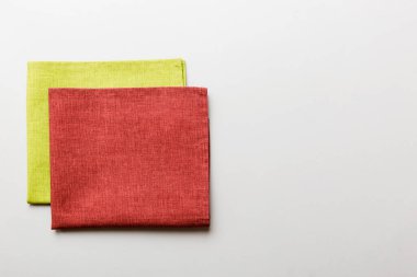 top view with red empty kitchen napkin isolated on table background. Folded cloth for mockup with copy space, Flat lay. Minimal style.
