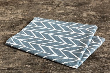 top view with blue kitchen napkin isolated on table background. Folded cloth for mockup with copy space, Flat lay. Minimal style.