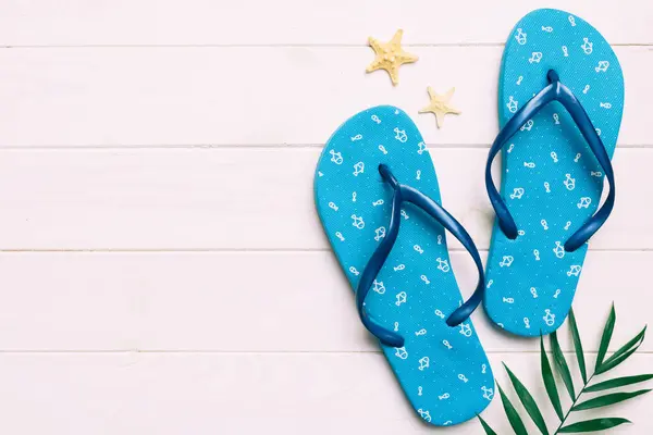 stock image Flat lay composition with flip flops and seashell on colored background. Space for text top view.