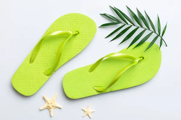 stock image Flat lay composition with flip flops and seashell on colored background. Space for text top view.