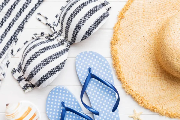 stock image Woman swimwear and beach accessories flat lay top view on colored background Summer travel concept. bikini swimsuit, straw hat and seasheels. Copy space Top view.