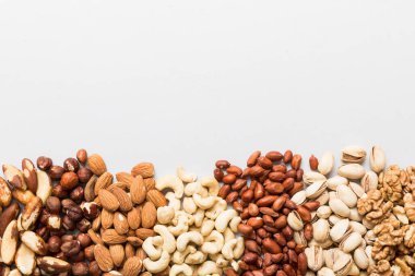 different nuts frame background. Close up, top view, flat lay with vopy space. Walnut, pistachios, almonds, hazelnuts and cashews.