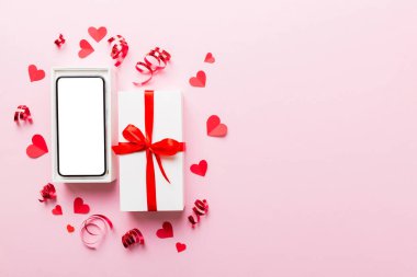 Opened gift box with ribbon and phone on color background, top view. Blank open box packaging mockup , Template for your design - branding mockup.