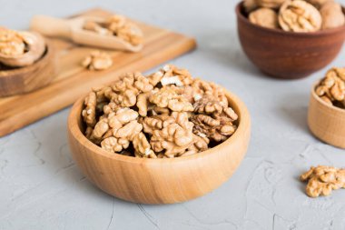Fresh healthy walnuts in bowl on colored table background. Top view Healthy eating bertholletia concept. Super foods.