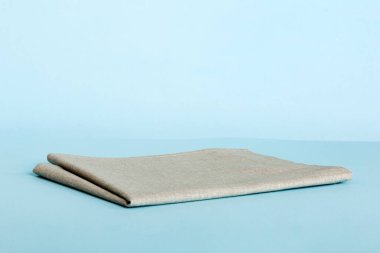 top view with gray kitchen napkin isolated on table background. Folded cloth for mockup with copy space, Flat lay. Minimal style.