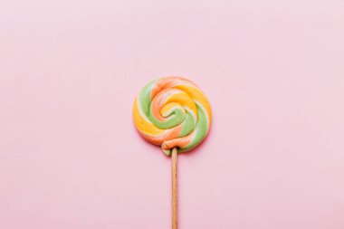 Colorful candies, lollypop on the colorful background, multicolored minimal style top view.