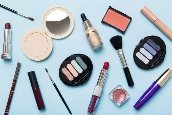 Professional makeup tools. Top view. Flat lay. Beauty, decorative cosmetics. Makeup brushes set and color eyeshadow palette on table background. Minimalistic style.