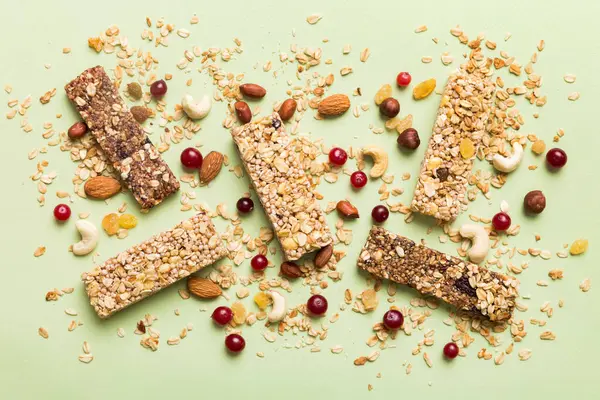 stock image Various granola bars on table background. Cereal granola bars. Superfood breakfast bars with oats, nuts and berries, close up. Superfood concept.