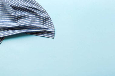 top view with blue kitchen napkin isolated on table background. Folded cloth for mockup with copy space, Flat lay. Minimal style.