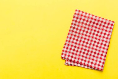 top view with red empty kitchen napkin isolated on table background. Folded cloth for mockup with copy space, Flat lay. Minimal style.