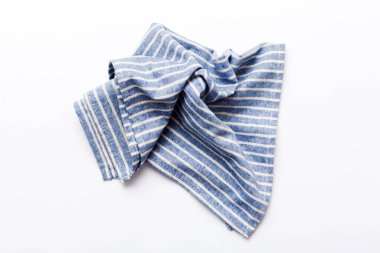 top view with blue kitchen napkin isolated on table background. Folded cloth for mockup with copy space, Flat lay. Minimal style.