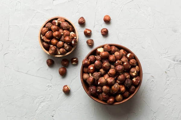 Wooden bowl full of hazelnuts on table background. Healthy eating concept. Super foods.