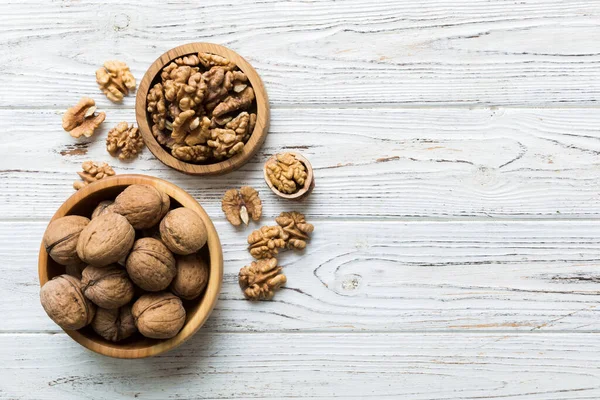 stock image Fresh healthy walnuts in bowl on colored table background. Top view Healthy eating bertholletia concept. Super foods.