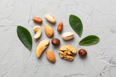 Composition of nuts , flat lay - mix hazelnuts, cashews, almonds on table background. healthy eating concepts and food background.