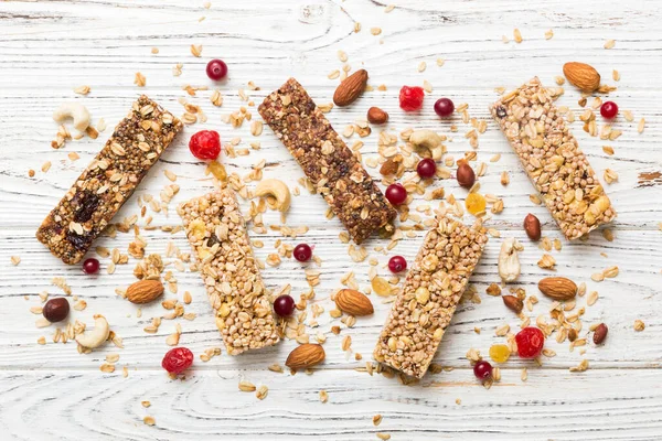 stock image Various granola bars on table background. Cereal granola bars. Superfood breakfast bars with oats, nuts and berries, close up. Superfood concept.